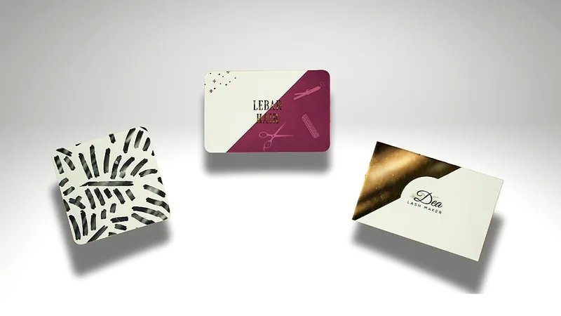 Three business cards with gold foil and graphic patterns